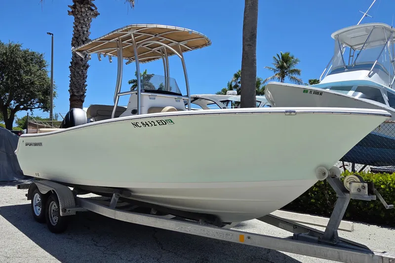 Slide: The Image of 2016 Sportsman Heritage 211 Center Console boat on trailer, parked outdoors. - 3