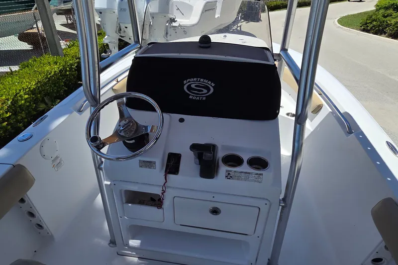 Slide: The Image of 2016 Sportsman Heritage 211 Center Console boat interior with steering wheel and controls. - 8