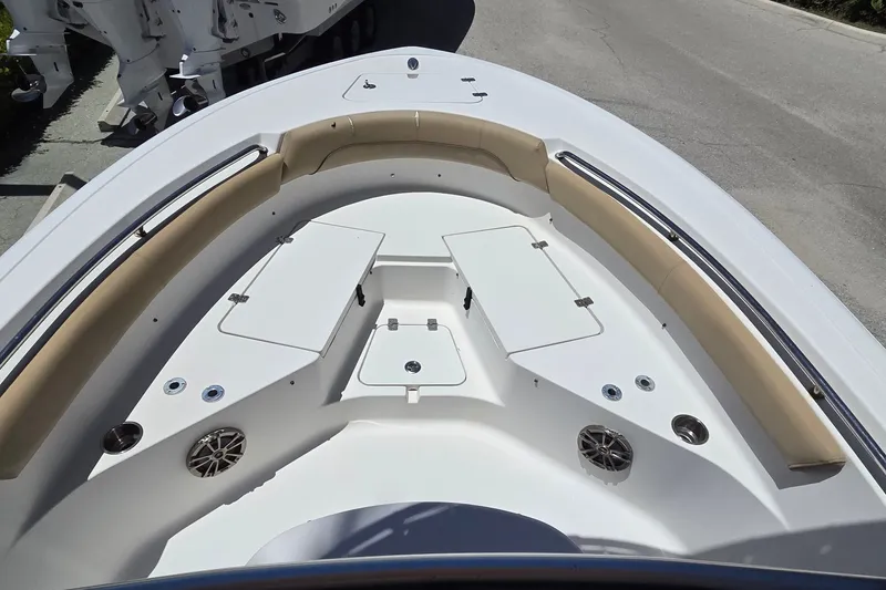 Slide: The Image of 2016 Sportsman Heritage 211 Center Console boat interior with cushioned seating and storage compartments. - 9