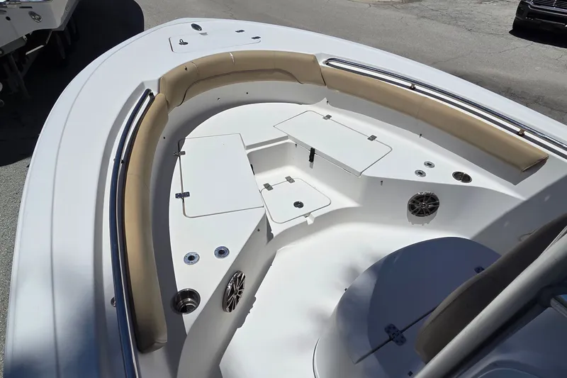 Slide: The Image of 2016 Sportsman Heritage 211 Center Console boat interior with cushioned seating and storage compartments. - 5