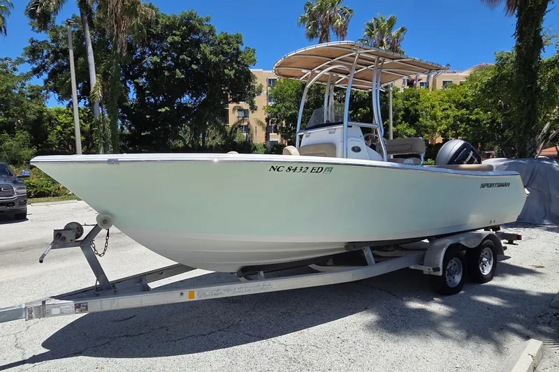 Slide: The Image of 2016 Sportsman Heritage 211 Center Console boat on trailer, parked outdoors. - 1