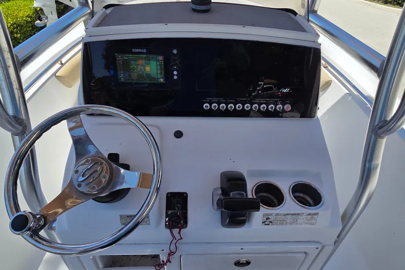 Slide: The Image of 2016 Sportsman Heritage 211 Center Console dashboard with steering wheel and controls. - 14