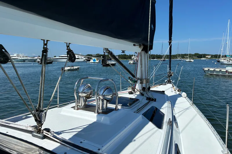Slide: The Image of Sailboat Freedom 35, 1996 model, docked in a marina with clear blue skies. - 3