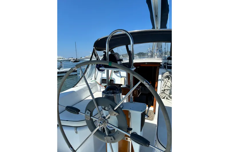 Slide: The Image of Sailboat cockpit with steering wheel, Freedom 35 model, 1996, docked in a marina. - 26