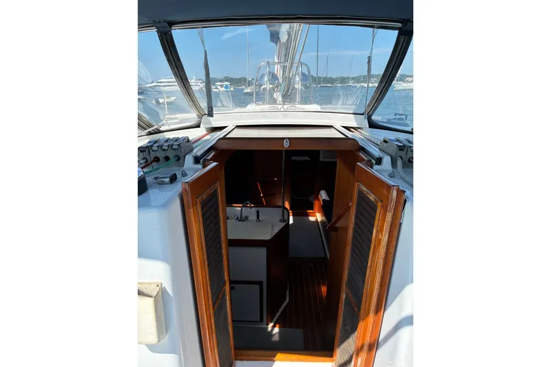 Slide: The Image of Interior view of a 1996 Freedom 35 sailboat cabin with open wooden doors. - 28