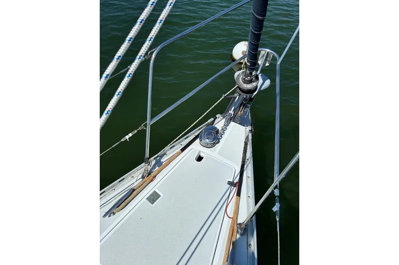 Slide: The Image of Bow of a 1996 Freedom 35 sailboat with rigging and winch, on calm water. - 22