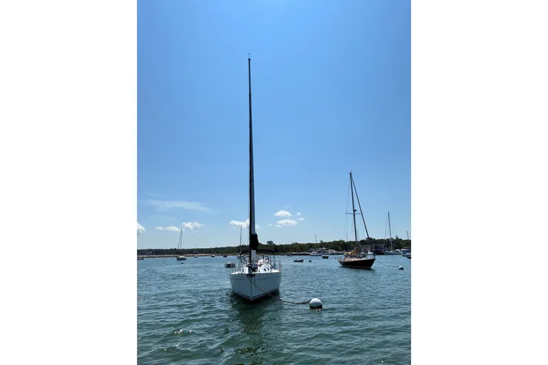 Slide: The Image of Sailboats anchored on a sunny day, featuring a 1996 Freedom 35 model. - 14