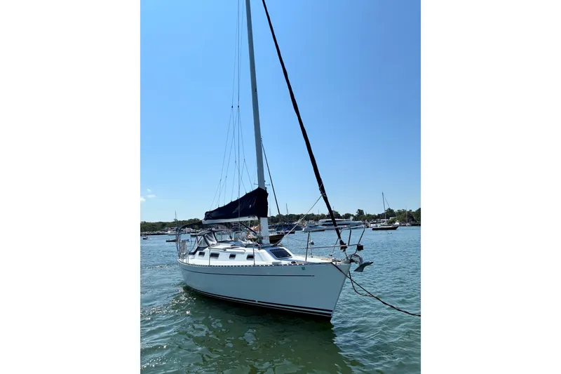 Slide: The Image of Sailboat Freedom 35, 1996 model, anchored in a sunny harbor. - 10