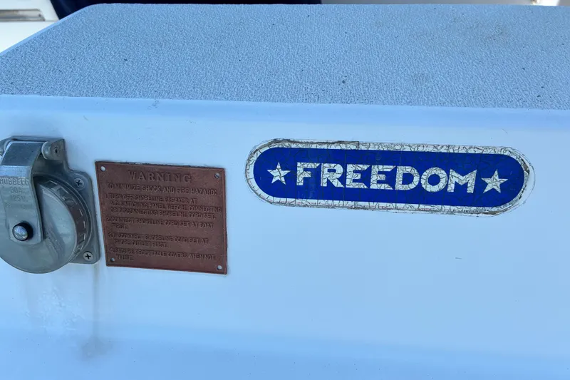 Slide: The Image of 1996 Freedom 35 boat with warning plaque and power outlet. - 34