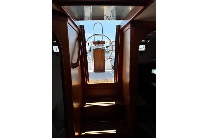 Slide: The Image of Interior view of 1996 Freedom 35 sailboat, showcasing wooden cabin steps and helm. - 16