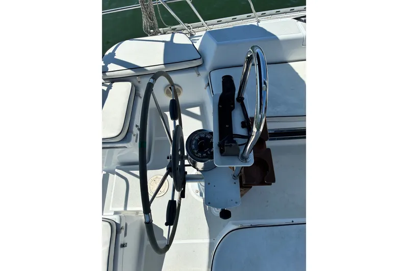 Slide: The Image of Steering wheel and compass on a 1996 Freedom 35 sailboat deck. - 5