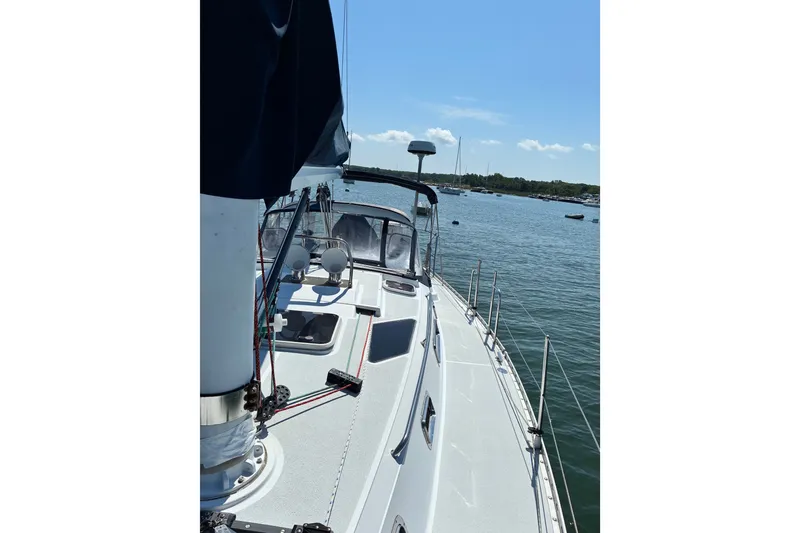 Slide: The Image of Sailboat Freedom 35, 1996 model, docked on calm water under clear blue sky. - 31