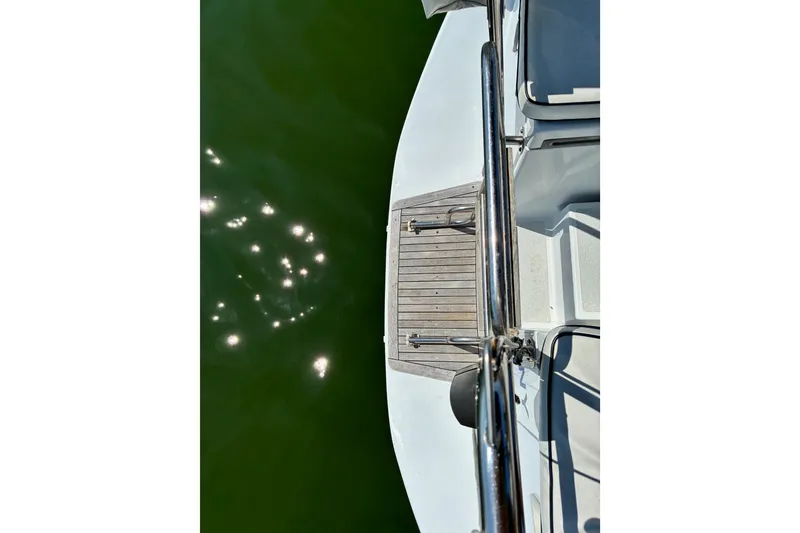 Slide: The Image of View from a 1996 Freedom 35 yacht deck, overlooking sparkling green water. - 27