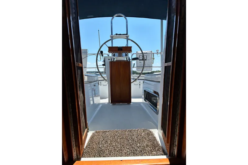Slide: The Image of Interior view of 1996 Freedom 35 sailboat cockpit with steering wheel and wooden accents. - 6