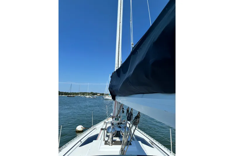 Slide: The Image of Sailboat Freedom 35, 1996 model, on calm waters under clear blue sky. - 12