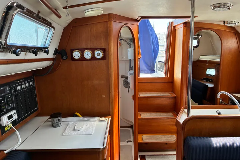 Slide: The Image of Interior of a 1996 Freedom 35 sailboat with wooden finishes and nautical instruments. - 4