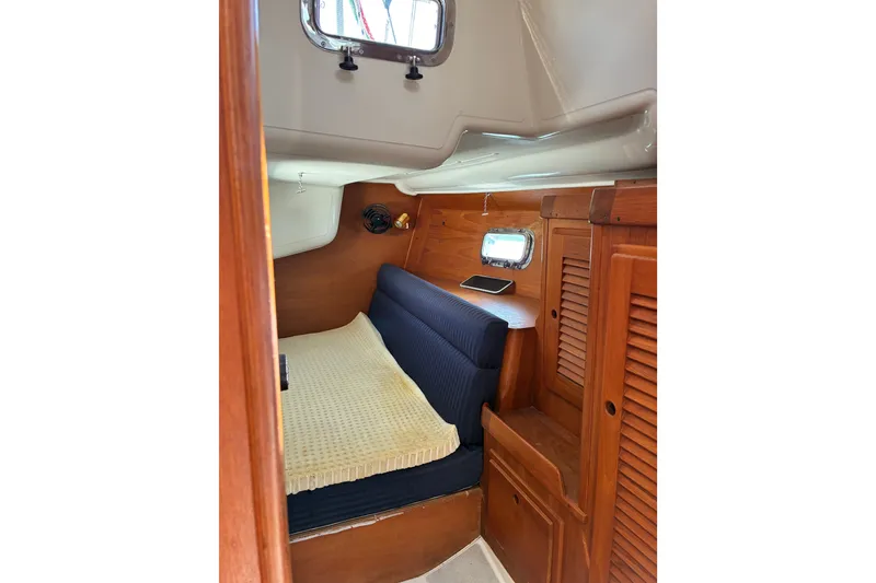 Slide: The Image of Cozy cabin interior of 1996 Freedom 35 sailboat with wooden furnishings. - 17