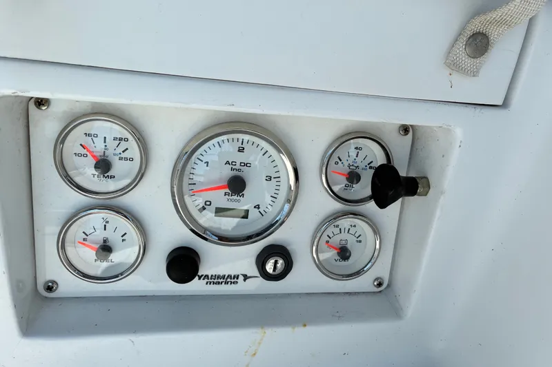 Slide: The Image of Boat dashboard with gauges for temperature, RPM, oil pressure, fuel, and voltage, Freedom 35, 1996. - 25