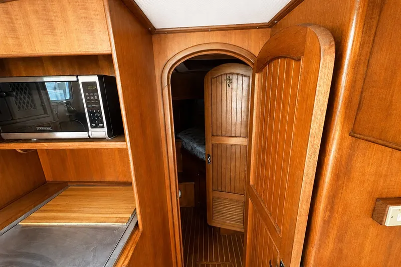 Slide: The Image of 1986 Marine Trader Labelle interior with wooden cabinetry and microwave. - 18