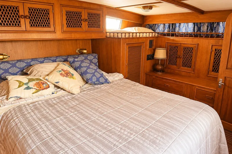 Slide: The Image of Cozy cabin interior of 1986 Marine Trader Labelle yacht with wooden furnishings and decorative pillows. - 26