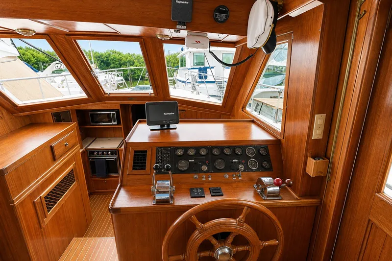 Slide: The Image of 1986 Marine Trader Labelle yacht helm with wooden interior and navigation equipment. - 12