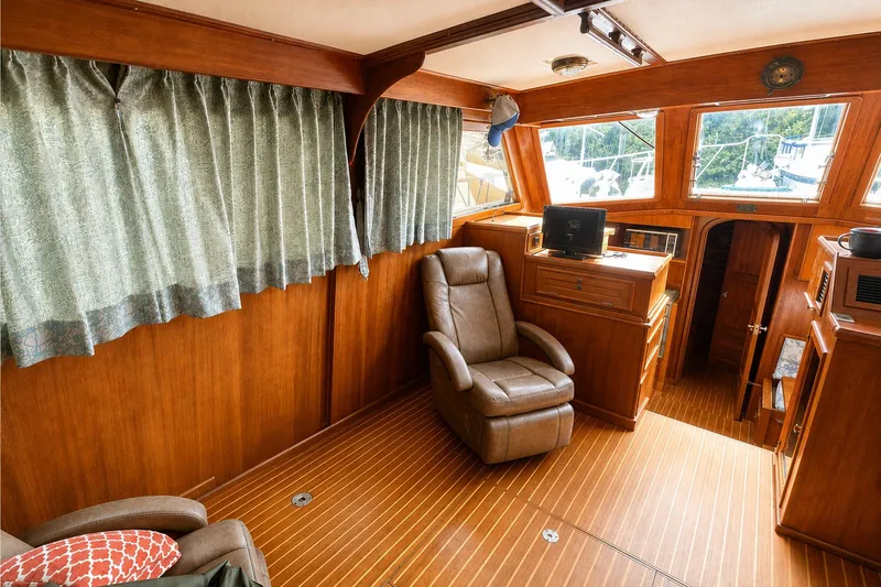 Slide: The Image of Interior of 1986 Marine Trader Labelle yacht with wood paneling and comfortable seating. - 9