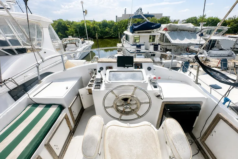 Slide: The Image of 1986 Marine Trader Labelle yacht cockpit with steering wheel and navigation equipment. - 6