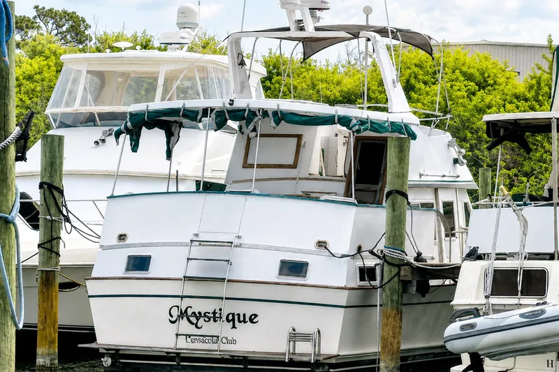 Slide: The Image of 1986 Marine Trader Labelle yacht docked at marina with lush greenery. - 5