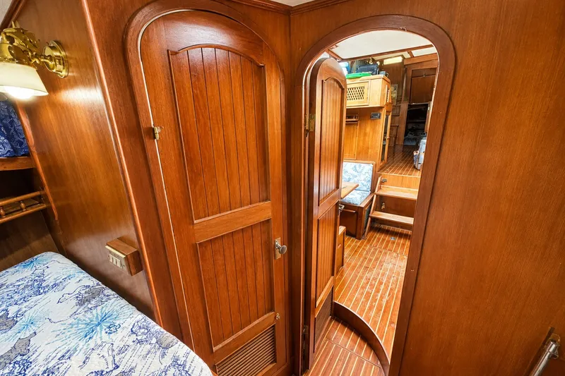 Slide: The Image of 1986 Marine Trader Labelle yacht interior with wooden doors and cozy cabin space. - 21