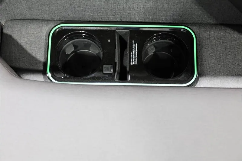 Slide: The Image of Car cup holder in 2026 Evotti 723CS interior, featuring sleek design and green accent lighting. - 22
