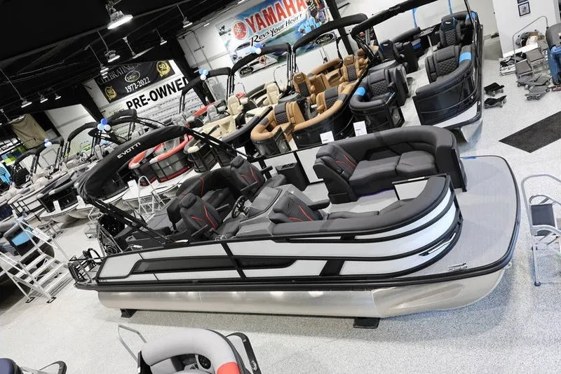 The Image of 2026 Evotti 723CS pontoon boat displayed in a showroom with other boats. - 1