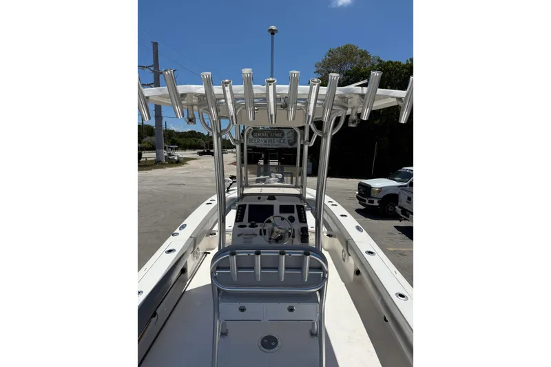 Slide: The Image of 2017 Robalo 246 Cayman boat interior with rod holders and steering console. - 15