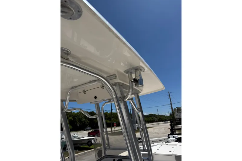 Slide: The Image of 2017 Robalo 246 Cayman boat T-top structure under clear blue sky. - 13