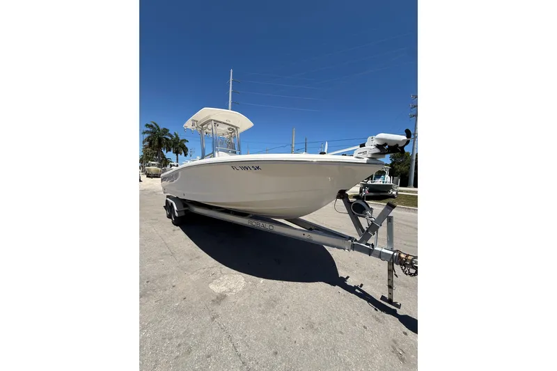 Slide: The Image of 2017 Robalo 246 Cayman boat on trailer under clear blue sky. - 6