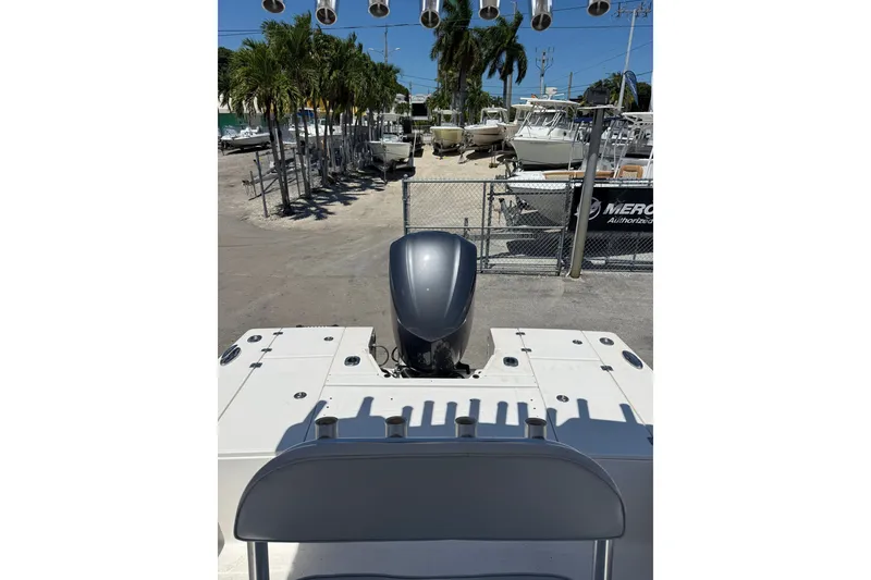 Slide: The Image of 2017 Robalo 246 Cayman boat with outboard motor, parked in a marina. - 9