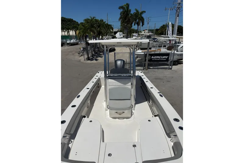 Slide: The Image of 2017 Robalo 246 Cayman boat interior with seating and console, docked outdoors. - 10