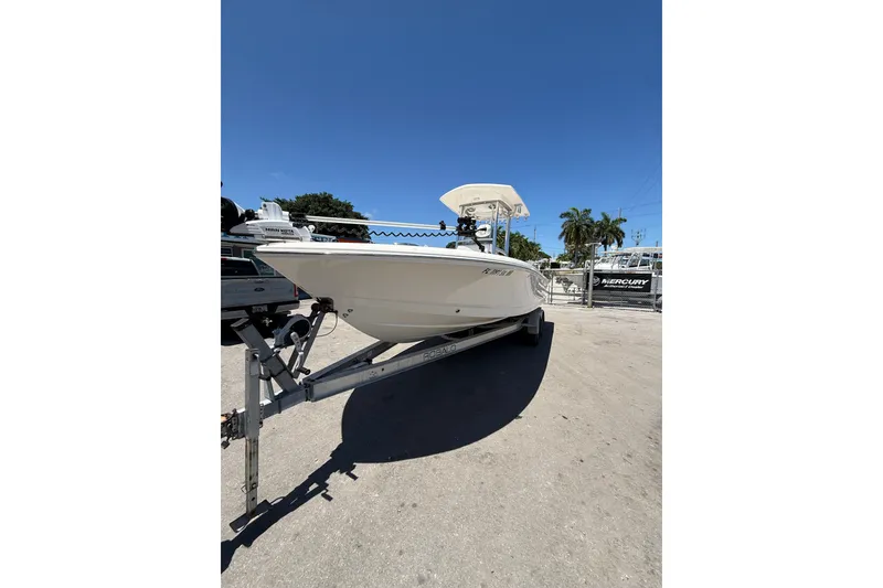 Slide: The Image of 2017 Robalo 246 Cayman boat on trailer under clear blue sky. - 3