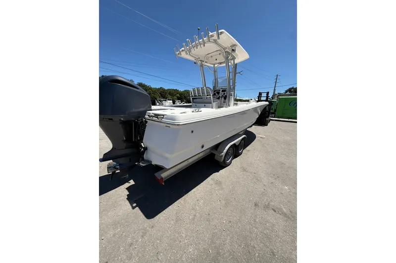 Slide: The Image of 2017 Robalo 246 Cayman boat on trailer, featuring a sleek design and powerful outboard motor. - 5