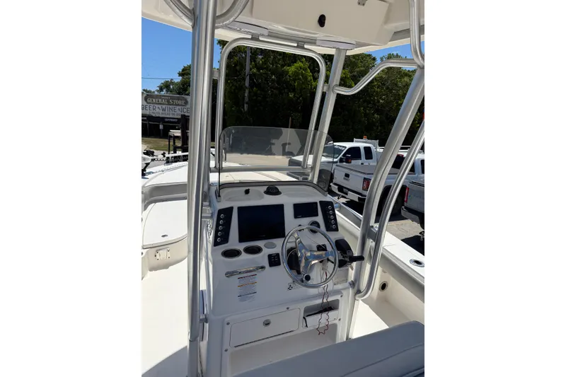 Slide: The Image of 2017 Robalo 246 Cayman boat console with steering wheel and navigation controls. - 16