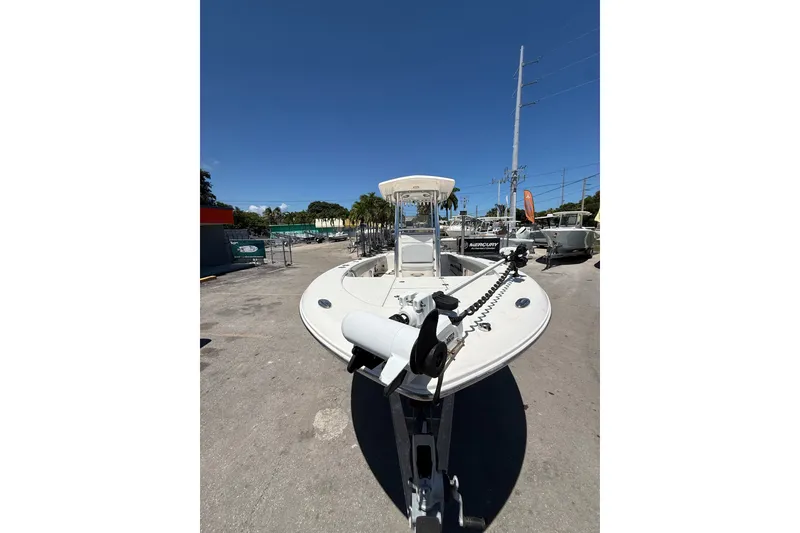 Slide: The Image of 2017 Robalo 246 Cayman boat on trailer under clear blue sky. - 2