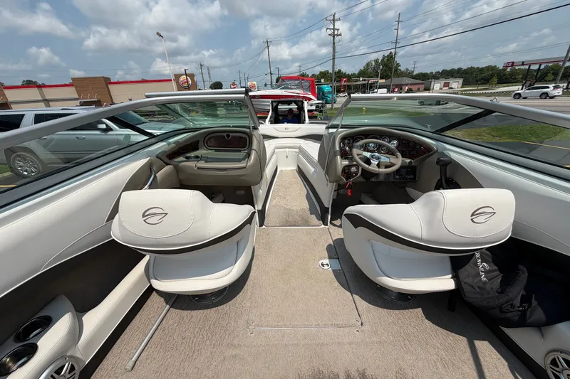 Slide: The Image of Interior view of a 2015 Crownline 21 SS boat, featuring sleek seating and dashboard controls. - 5