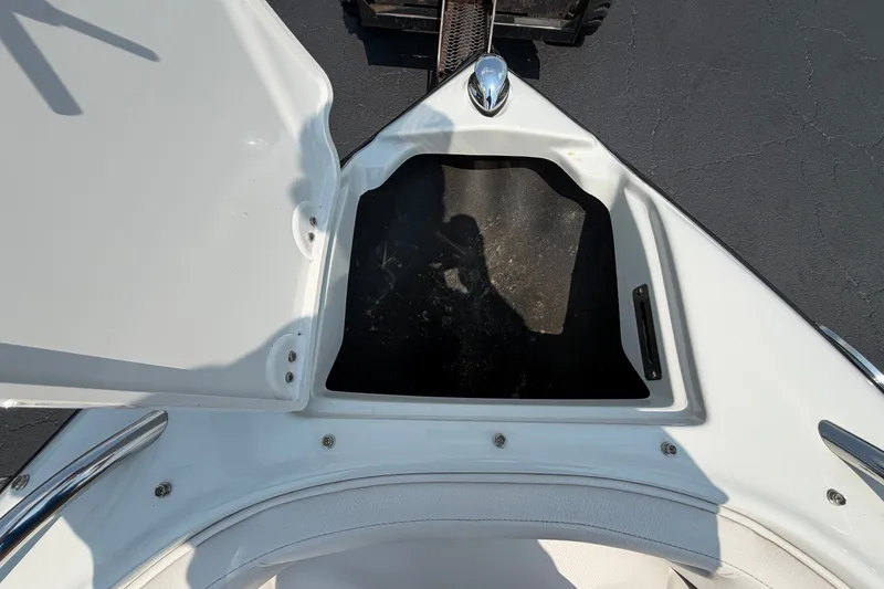 Slide: The Image of Open storage compartment on 2015 Crownline 21 SS boat, showing interior space. - 4