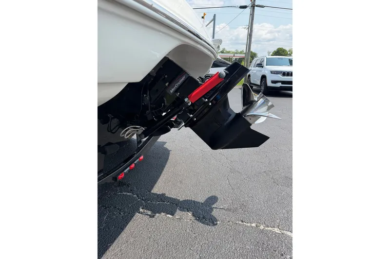 Slide: The Image of 2015 Crownline 21 SS boat with MerCruiser outdrive, parked on asphalt. - 18