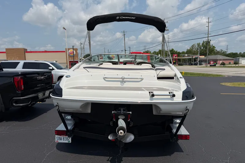 Slide: The Image of 2015 Crownline 21 SS boat on trailer in parking lot, sunny day. - 2