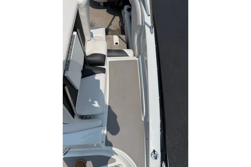 Slide: The Image of 2015 Crownline 21 SS boat interior with white seating and gray flooring. - 19