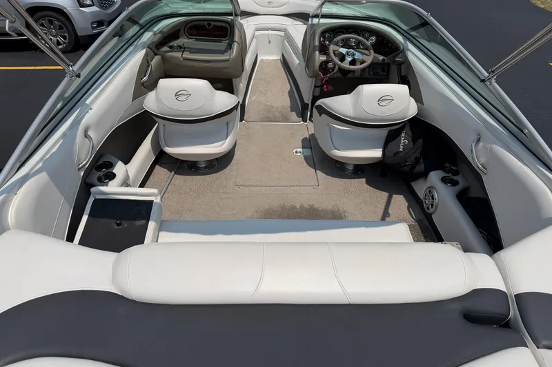 Slide: The Image of Interior of a 2015 Crownline 21 SS boat with white seating and steering console. - 1