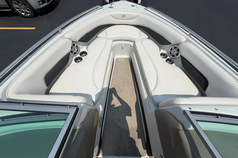 Slide: The Image of 2015 Crownline 21 SS boat interior with white seating and cup holders. - 9