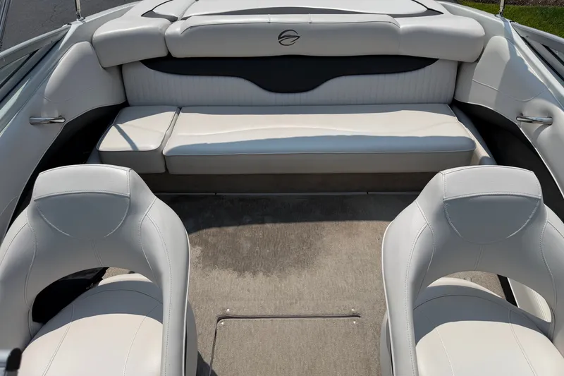 Slide: The Image of Interior of a 2015 Crownline 21 SS boat with white seating and carpeted floor. - 12