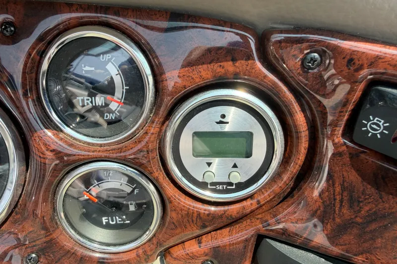 Slide: The Image of Dashboard of 2015 Crownline 21 SS boat with trim and fuel gauges. - 14