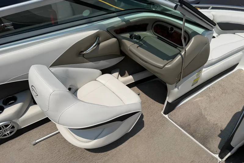 Slide: The Image of Interior of a 2015 Crownline 21 SS boat, featuring white seating and sleek design. - 10